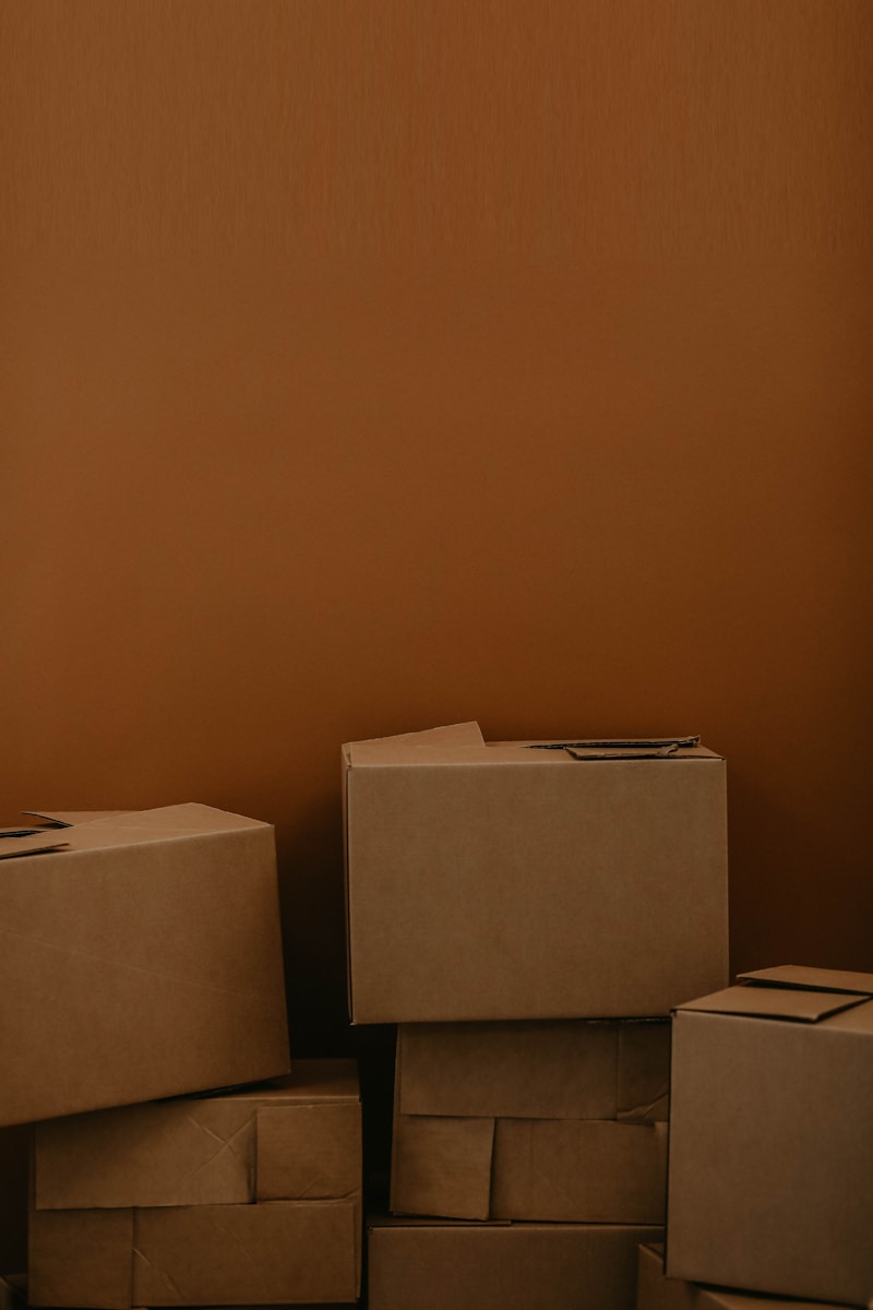 Photo by Kadarius Seegars white cardboard box on brown wooden table